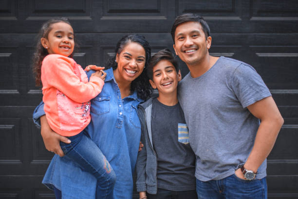 istock Family smiling together against wall 1137444189