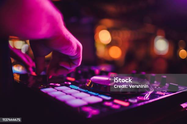Dj Remote Turntables And Hands Night Life At The Club Party Stock Photo - Download Image Now