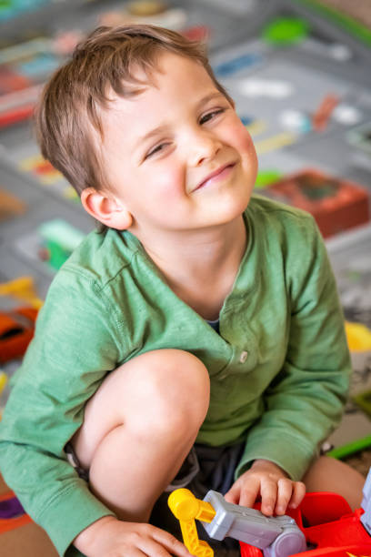istock Three years old child playing with his toys 1137445514