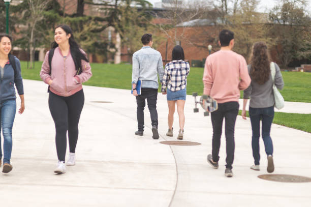 istock College students walking across campus to their classes 1137445706