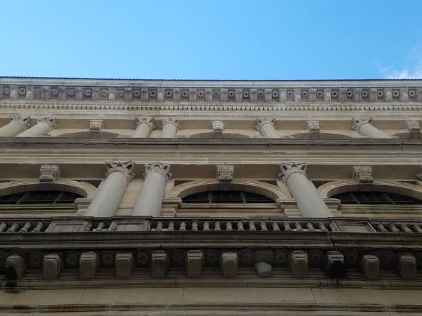 istock Ornate facade and eaves of building rooftop with sky overhead 1137445781