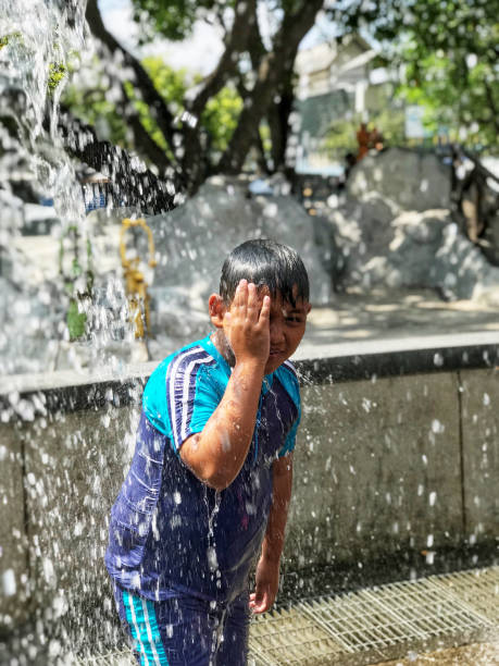 istock A fat boy is playing water on holiday. 1137446558