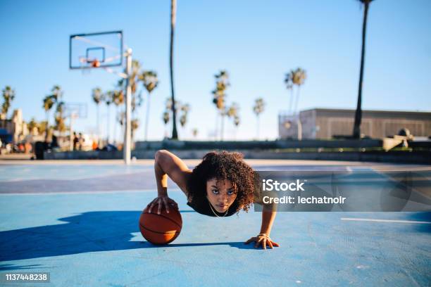 Low Angle Portrait Of A Young Women Doing One Hand Push Ups Stock Photo - Download Image Now
