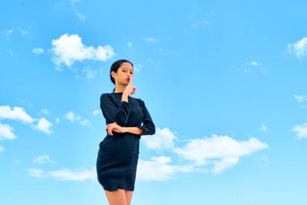 istock Attractive young woman standing on white sand 1137456645