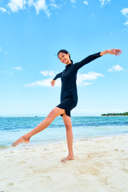 istock Attractive young woman standing on white sand 1137456656