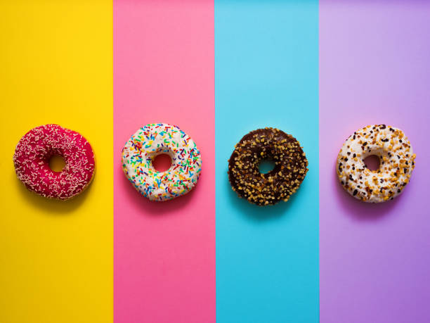 Sweet donuts on mmulti colored background