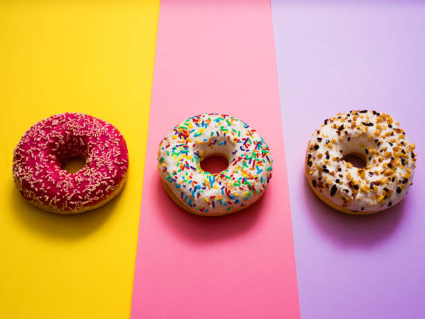istock Sweet donuts on mmulti colored background 1137458379