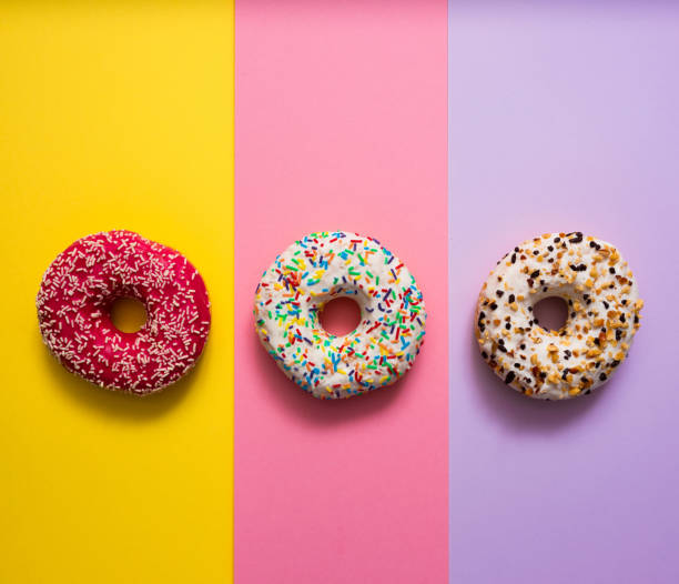 istock Sweet donuts on mmulti colored background 1137458384