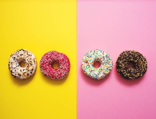 istock Sweet donuts on mmulti colored background 1137461240