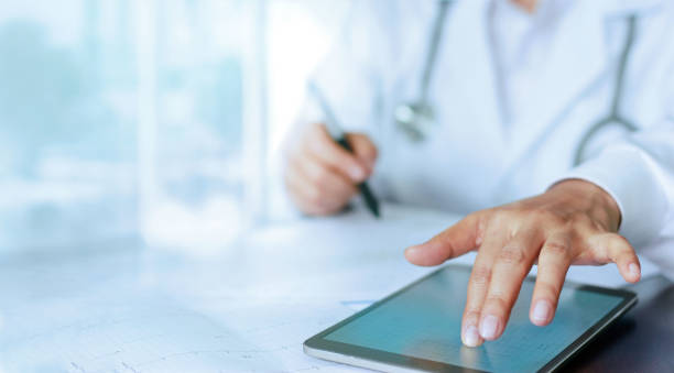 istock Medicine doctor hand touching  tablet computer interface as medical report network connection on screen, medical technology network concept 1137462223