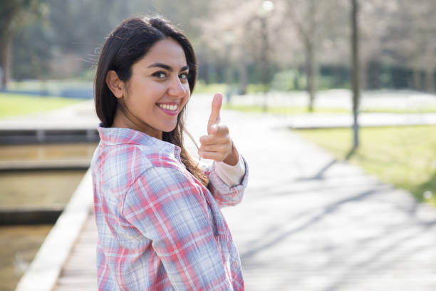 istock Cheerful girl making gun shot gesture 1137462975