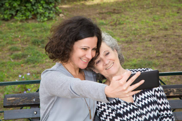 istock Cheerful mother and daughter taking selfie 1137464435
