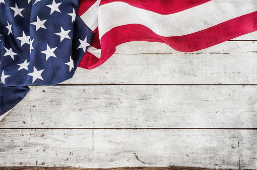 American flag on an old white wood background with textured effect