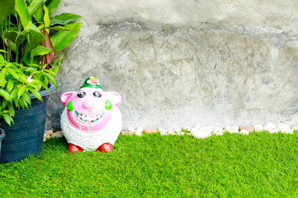 Green grass and stone with concrete wall for background