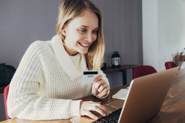 istock Cheerful businesswoman scanning credit card using web camera 1137465601