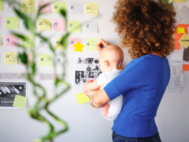 istock Working Mother Balancing Baby and Design Work 1137467996