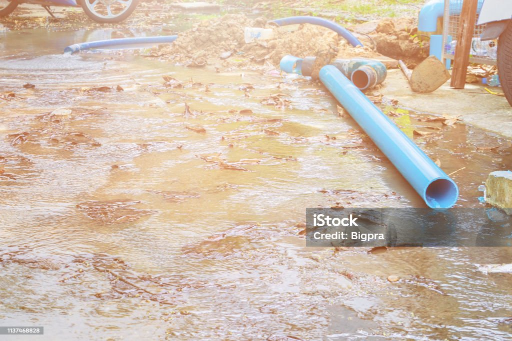 broken pipe in hole with water motion at roadside wait repair Accuracy Stock Photo