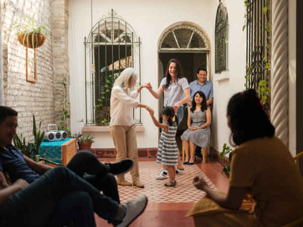 istock Joyful granddaughters dancing with their grandmother 1137469581