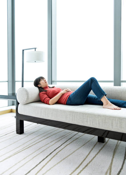 istock Woman taking nap on sofa 1137473644