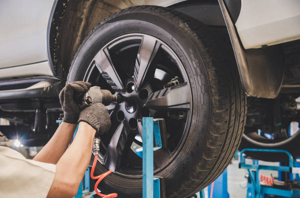 the car mechanic is changing the tire. - repairing auto repair shop service technician imagens e fotografias de stock