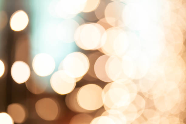 istock Blurry background of many little light bulb decorations in night party. 1137477106