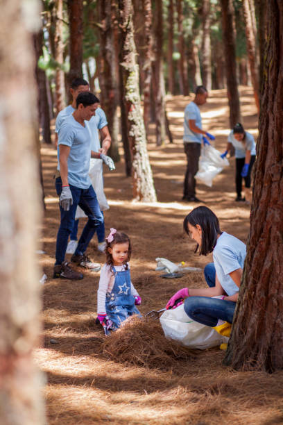 istock People recycling and picking up trash in the forest 1137483206