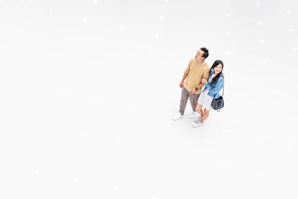 istock Asian Couple Walking Through a Brightly Lit Shopping Mall 1137484343