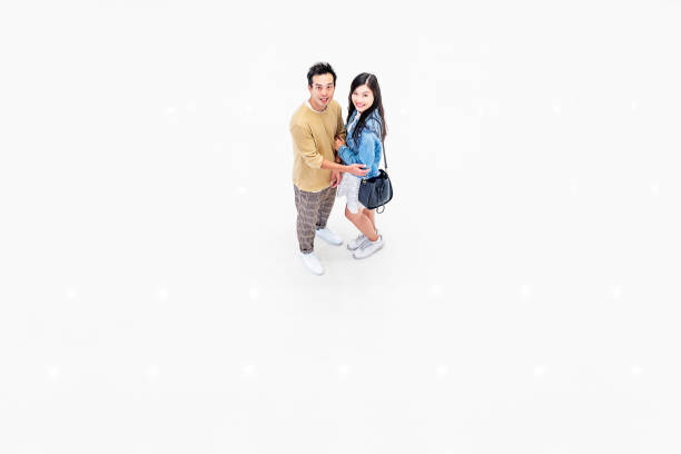 istock Asian Couple Walking Through a Brightly Lit Shopping Mall 1137484355