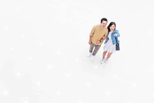 istock Asian Couple Walking Through a Brightly Lit Shopping Mall 1137484359