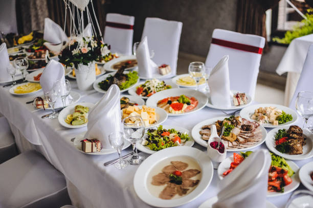 Wedding table, food, drinks, water.
Table with silver and glass stemware at restaurant before starting to celebrate a wedding.
Cheese, meat, salads. The holiday table