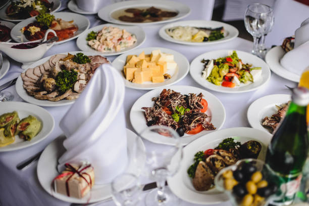 istock Wedding table, food, drinks, water.Table with silver and glass stemware at restaurant before starting to celebrate a wedding.Cheese, meat, salads. The holiday table 1137487128