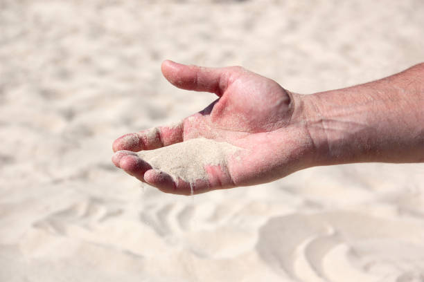 istock a handful of sand in the human palm 1137487545