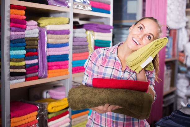 istock Young female customer examining various towels 1137487568