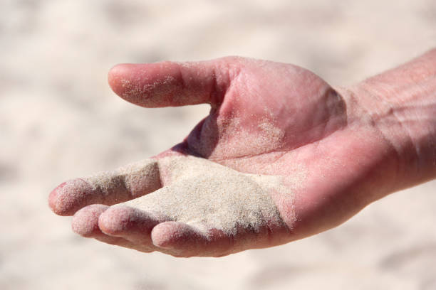 istock a handful of sand in the human palm 1137487570
