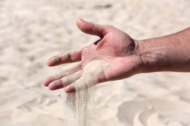 sand pours from the male palm close-up