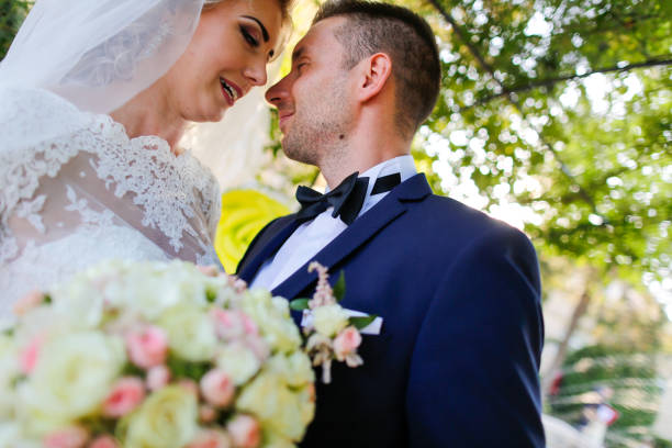 istock Beautiful wedding couple posing in garden 1137490107