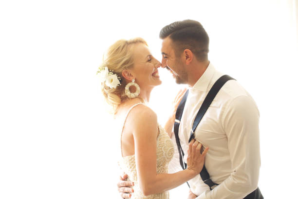 istock happy newly married couple posing by the window. 1137492986