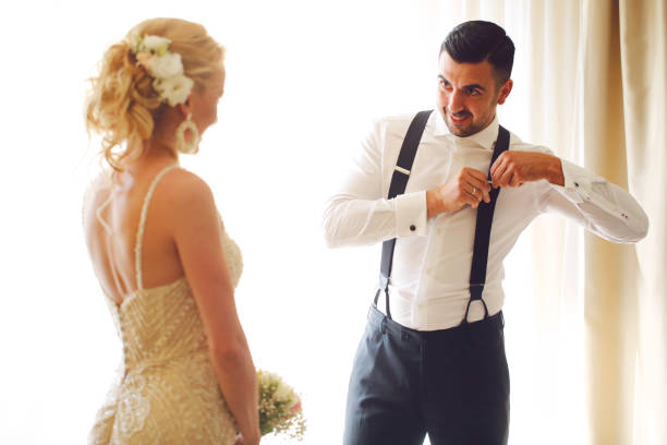 istock happy newly married couple posing by the window. 1137493009
