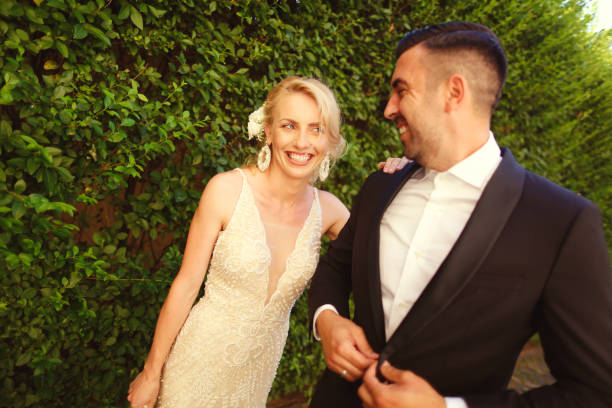istock Blonde bride and groom walking in park on their wedding day 1137493049
