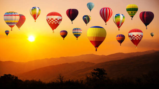 istock Hot air balloon above high mountain at sunset 1137495260