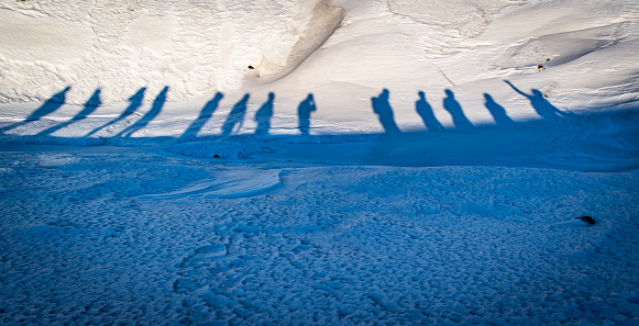 Shadows of hikers on snow