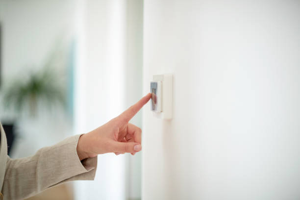 Index finger touching the light switch Hand turning the lights off with index finger light switch photos stock pictures, royalty-free photos & images