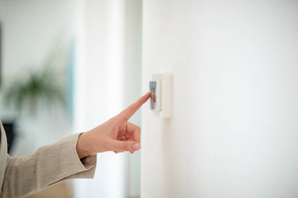 index finger touching the light switch - pushing women wall people imagens e fotografias de stock