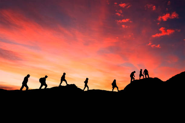istock eight friends walk on mountain path in sunset 1137498968