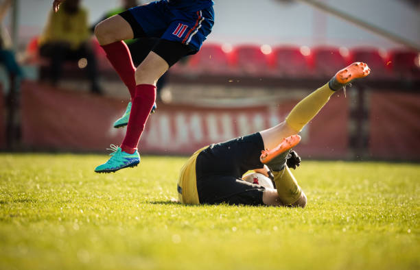 istock Goalkeeper saving a goal during sports match on playing field. 1137499217