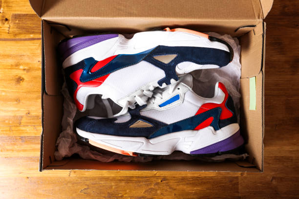 istock new sneakers in the box on wooden background- Image 1137500605
