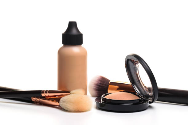 istock Liquid makeup foundation cream and  shadow, blush, powder, sculptor in a pack with make up brushes on a white background. Isolated on white. - 1137502273