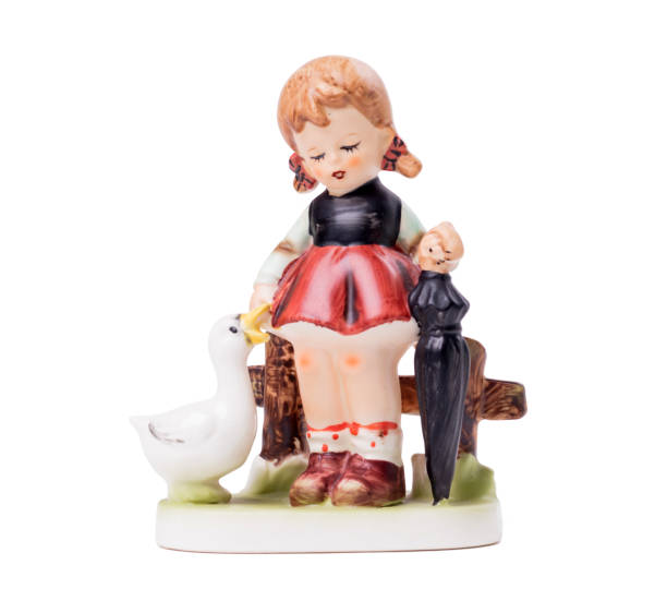 Very old statue, small ceramic girl with a goose, isolated on white