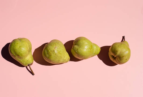 istock Close-Up Of Pears Against Pink Background 1137503988