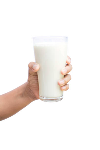 istock Cropped Hand Having Milk In Glass Against White Background 1137506328